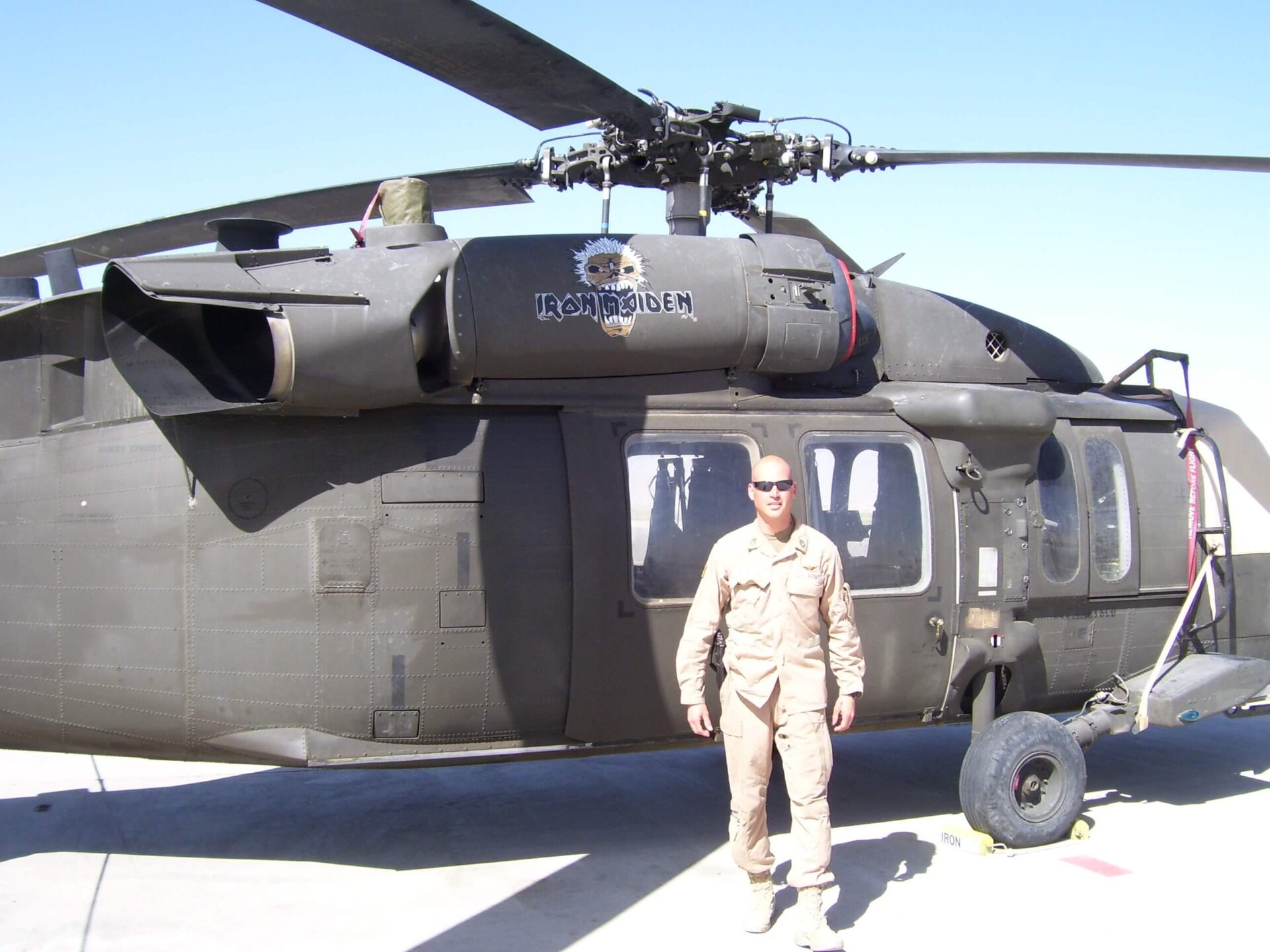 A person standing in front of ash colored chopper